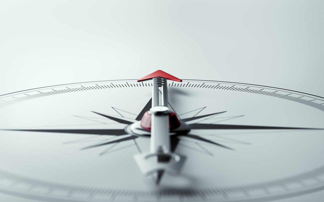 Compass on White Background with Selective Focus Compass on white background with selective focus. Compass is lit from the upper left corner of composition. Horizontal composition with copy space.